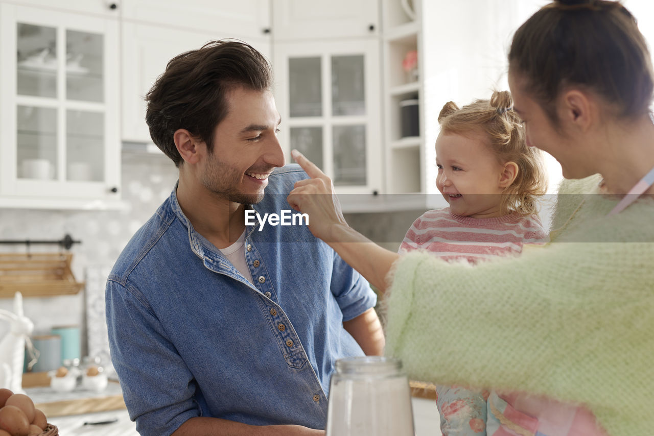 Family preparing food in kitchen