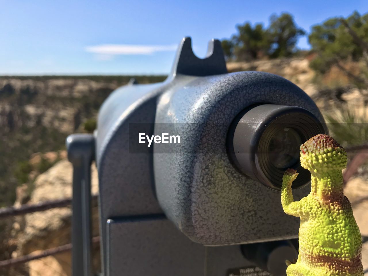 CLOSE-UP OF COIN-OPERATED BINOCULARS AGAINST SKY