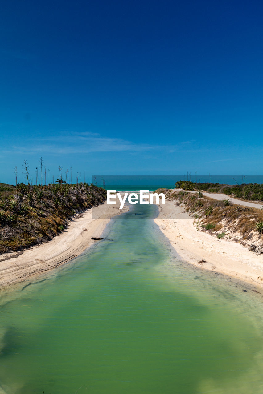 Scenic view of land against clear blue sky