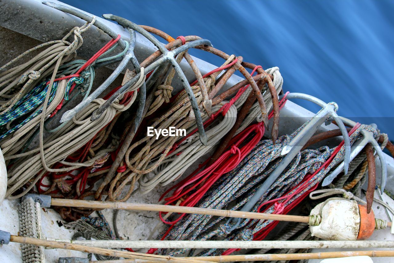 High angle view of various ropes in boat on lake