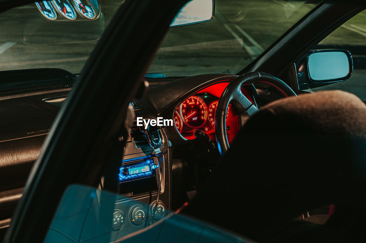 car, transportation, mode of transportation, motor vehicle, vehicle, automobile, vehicle interior, steering wheel, land vehicle, glass, car interior, windshield, travel, driving, indoors, control panel, dashboard, one person, luxury vehicle, adult, men, family car, rear-view mirror, wheel, auto part