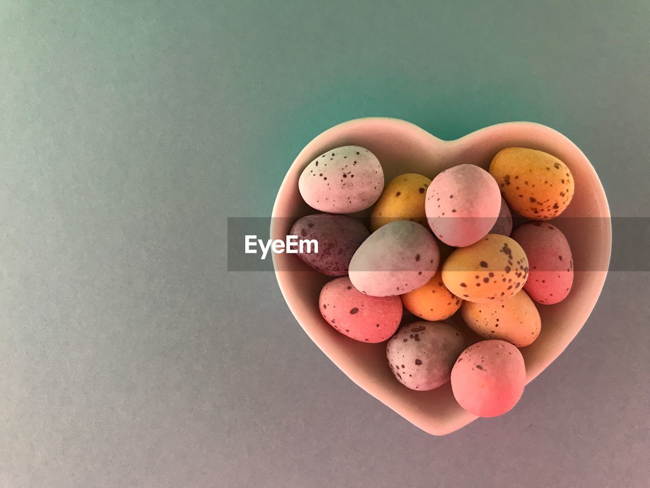 Sugarcoated mini chocolate easter eggs in a heart shaped dish 