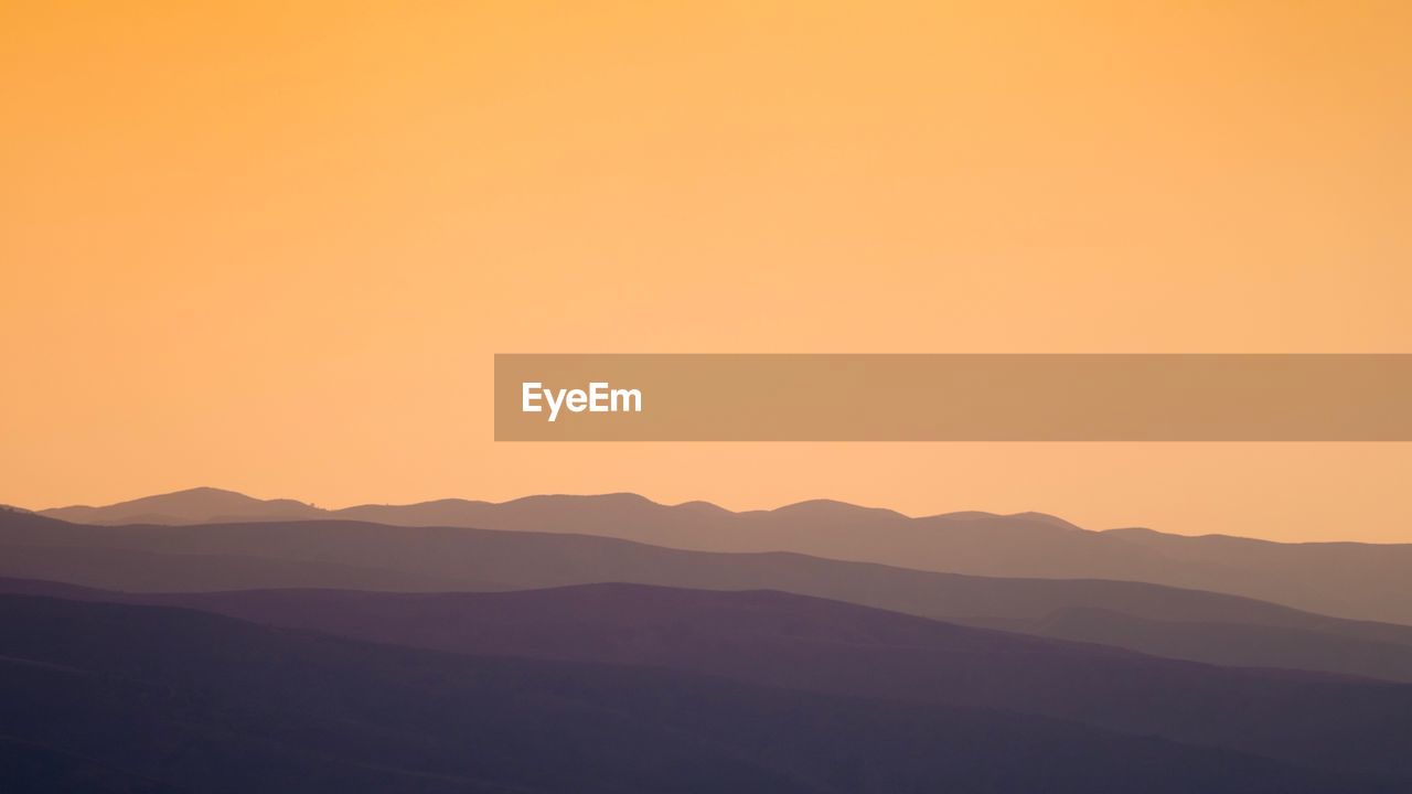 Scenic view of silhouette mountains against clear sky