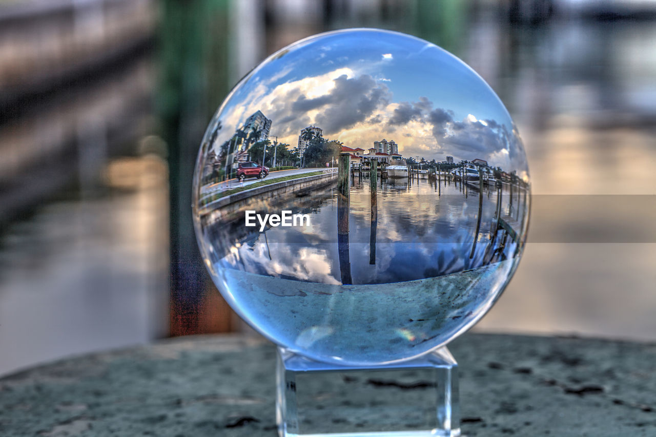 Crystal ball of boats docked at a marina near venetian bay in naples, florida at sunrise.