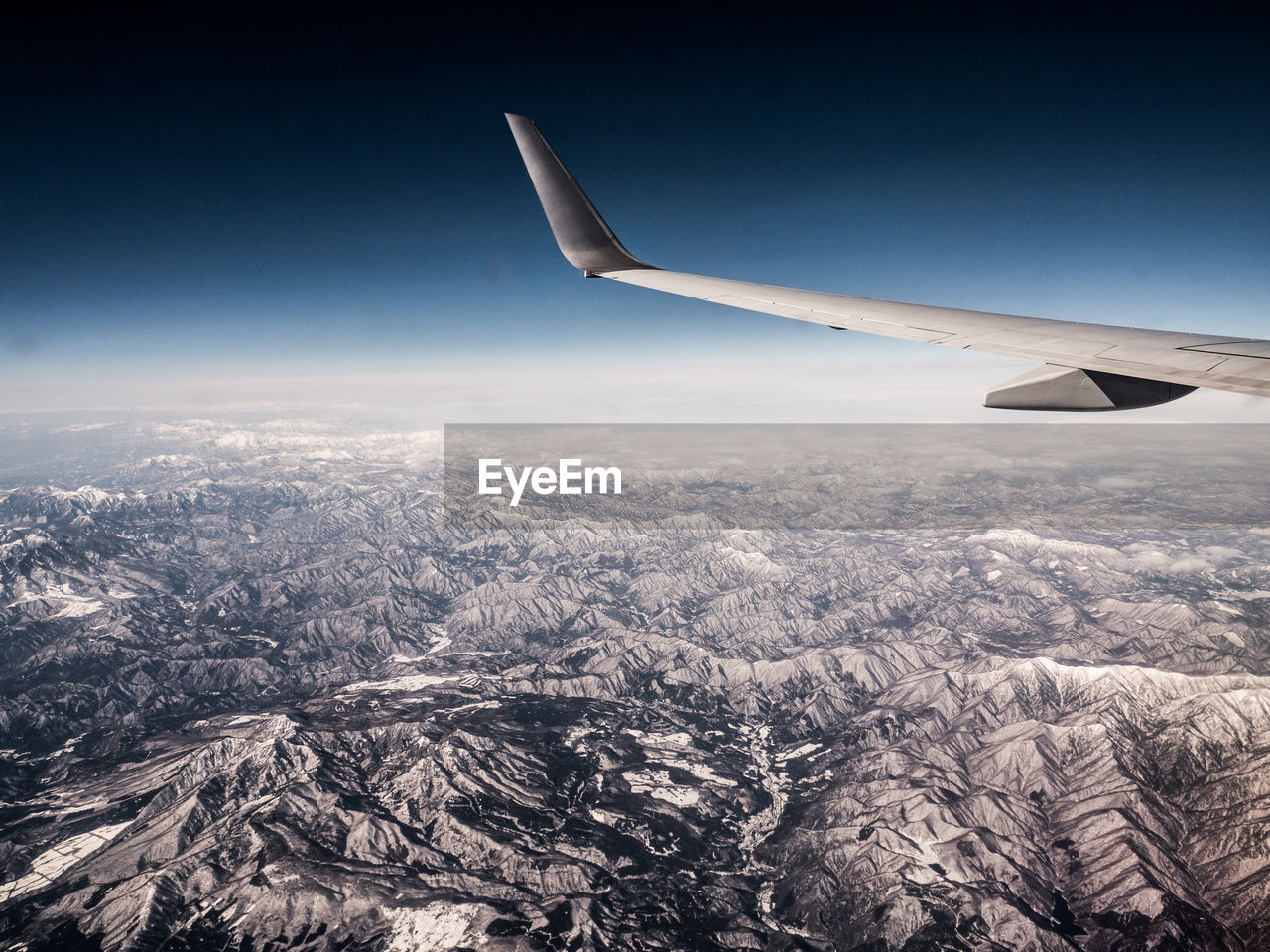 Aerial view of aircraft wing against sky