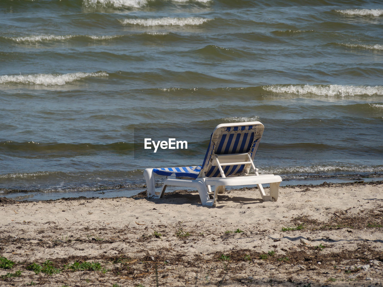 EMPTY CHAIRS ON BEACH