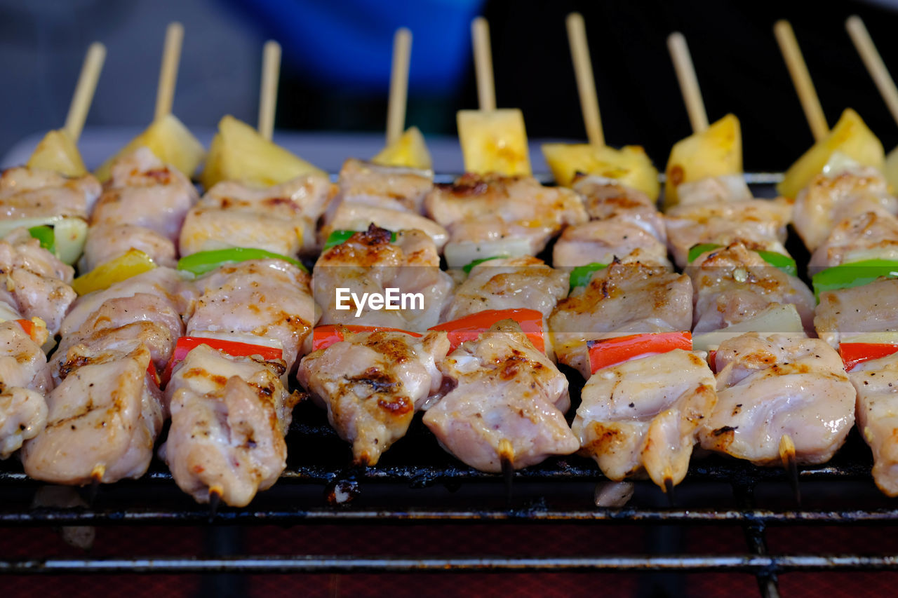 CLOSE-UP OF MEAT ON BARBECUE