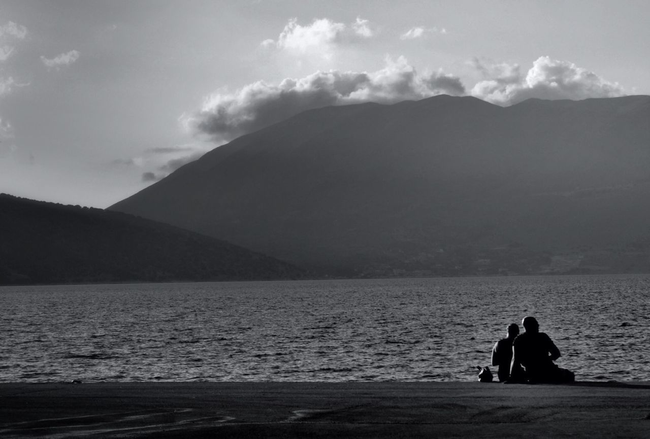 Two people on lakeshore