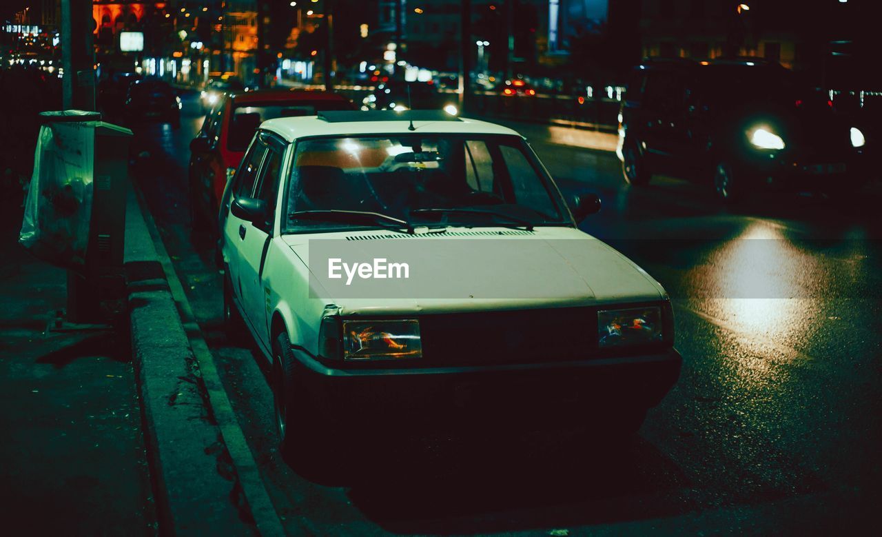 Cars on city street at night