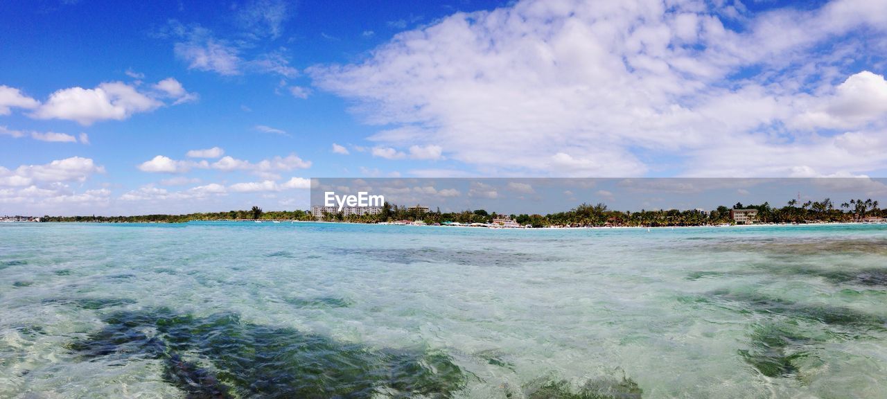 Scenic view of calm sea against cloudy sky