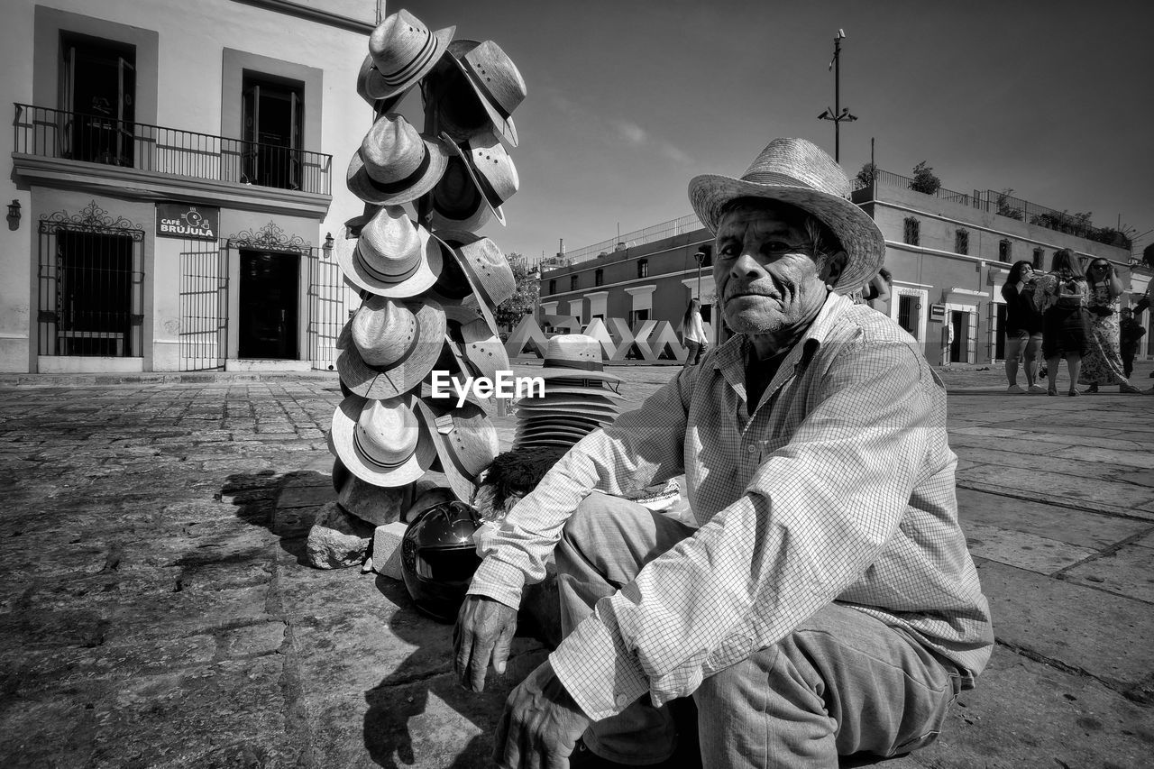 PANORAMIC VIEW OF MAN SITTING AT HISTORIC BUILDING