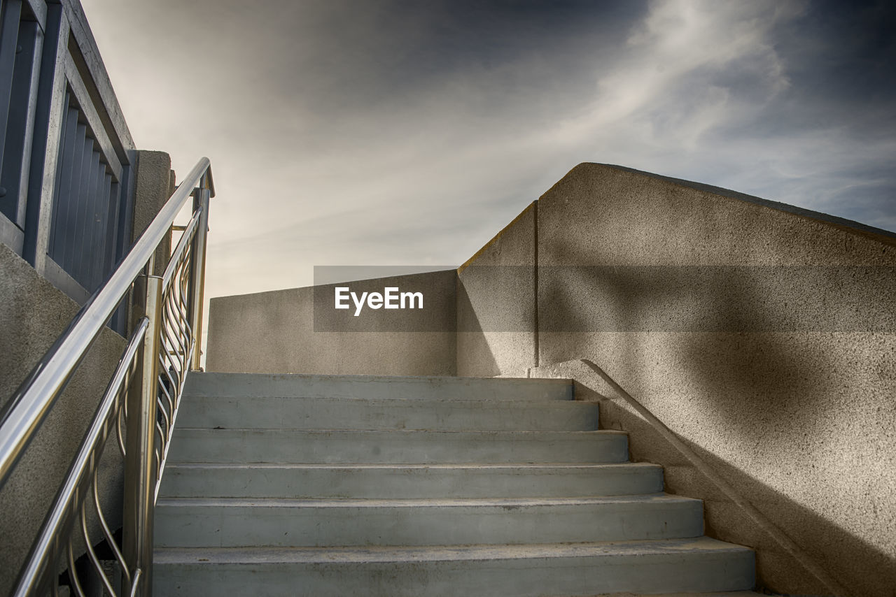 Concrete staircase to the sky with dramatic clouds