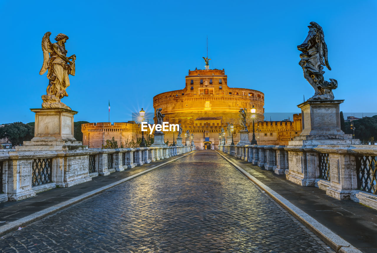 The castel sant angelo and the sant angelo bridge in rome at dawn