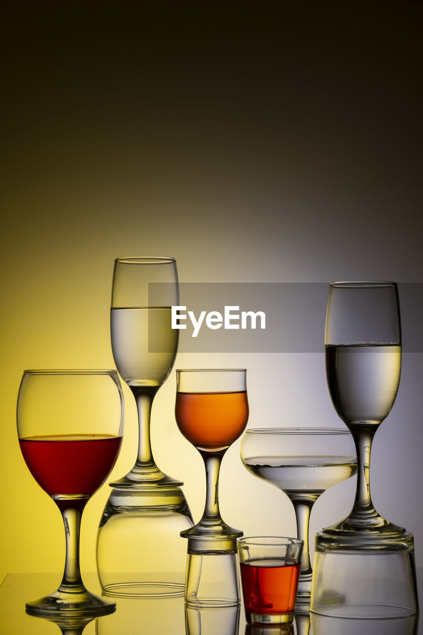 Glassware of different sizes against colorful background