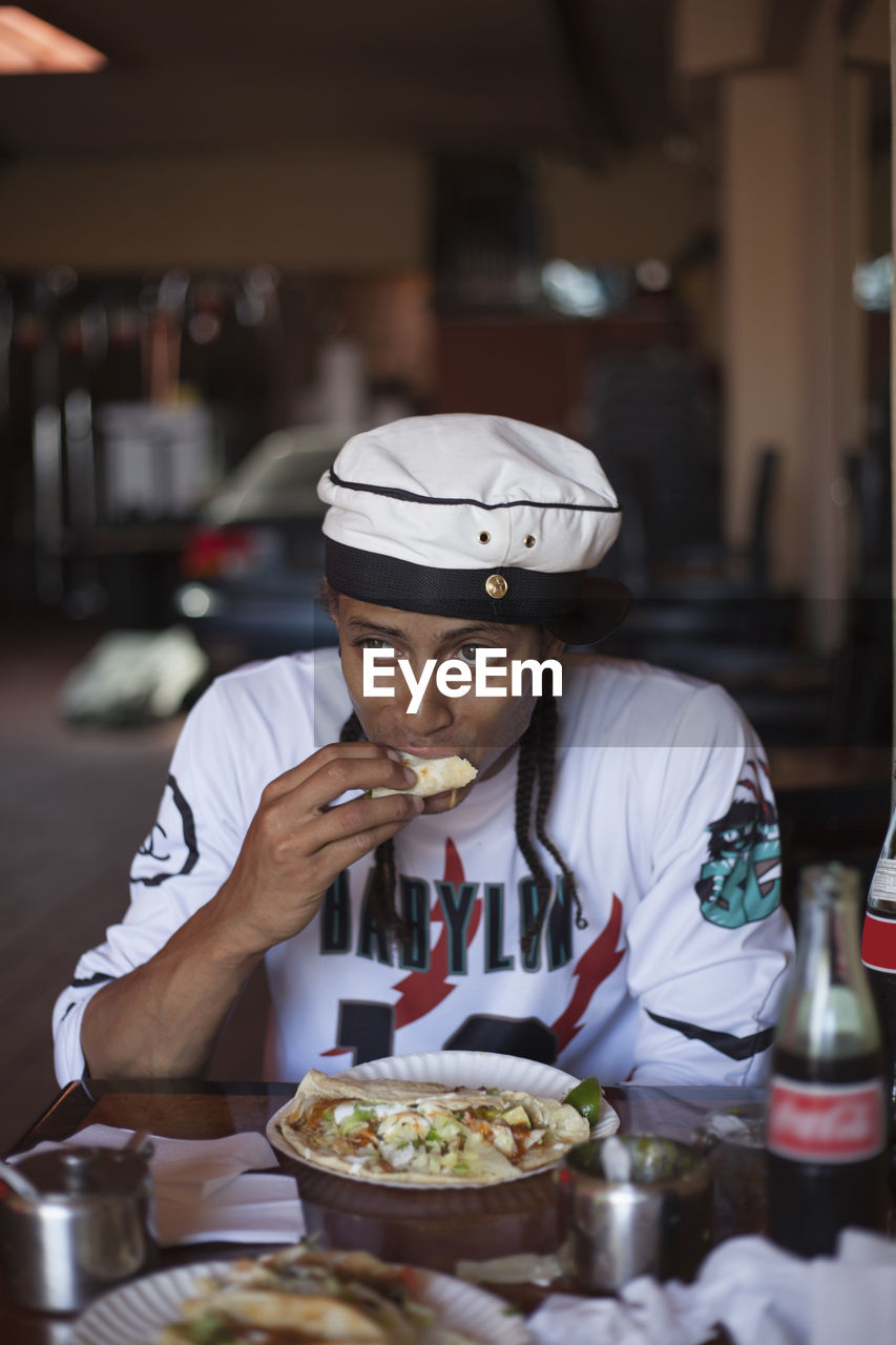 Young man eating at a restaurant