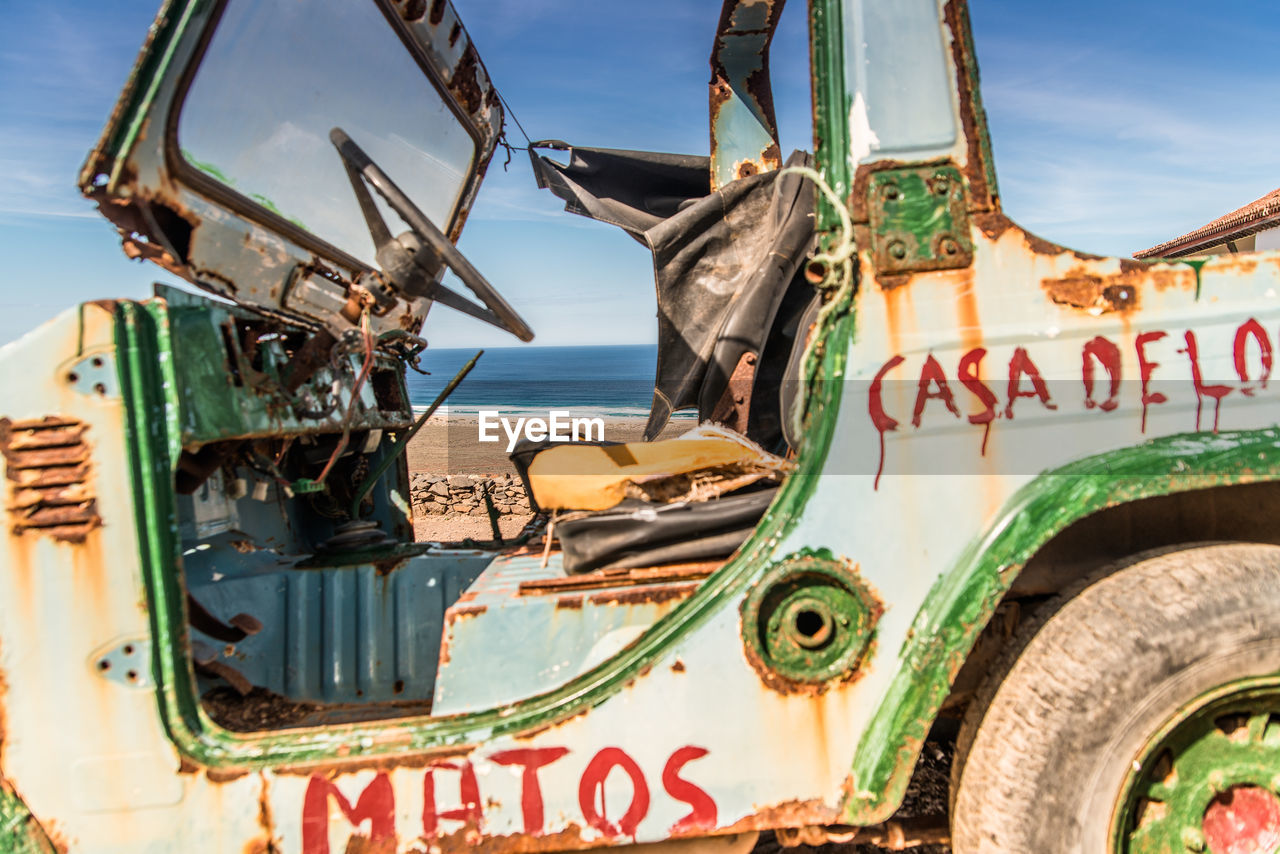 CLOSE-UP OF ABANDONED VEHICLE