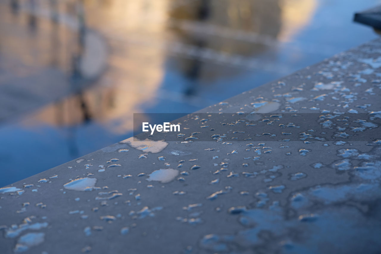 CLOSE-UP OF WET RAILING