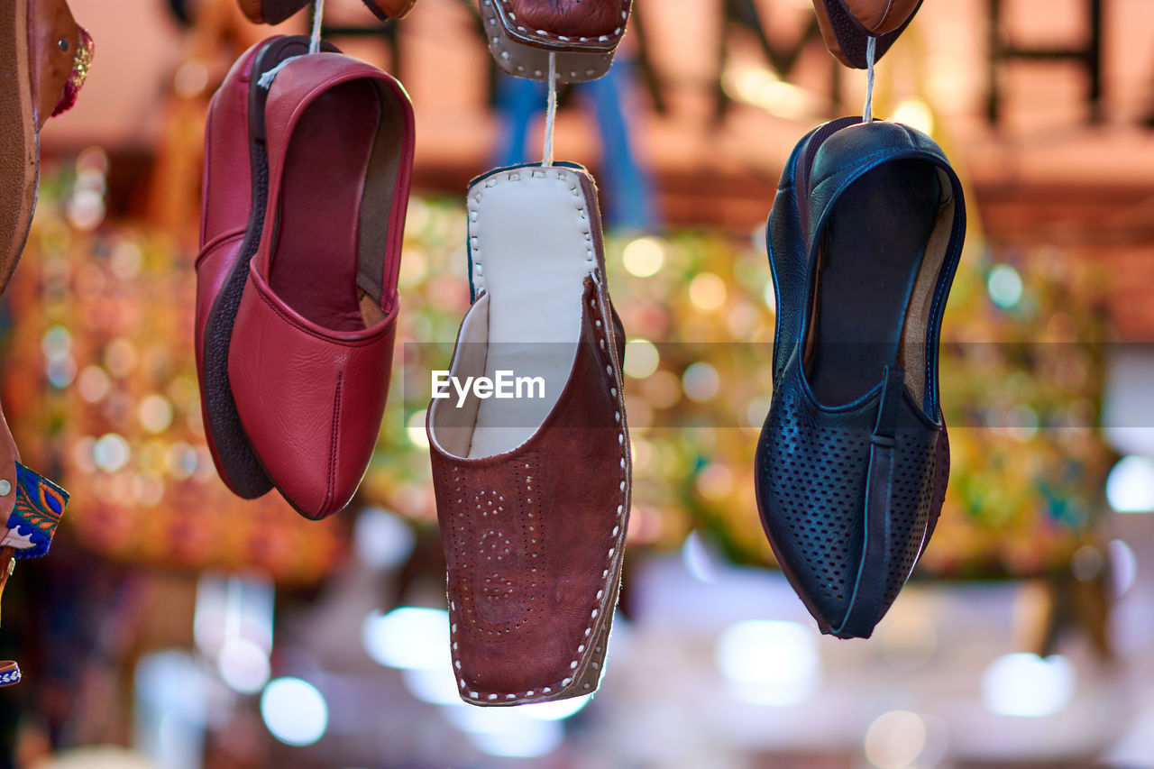 Close-up of shoes hanging at market stall
