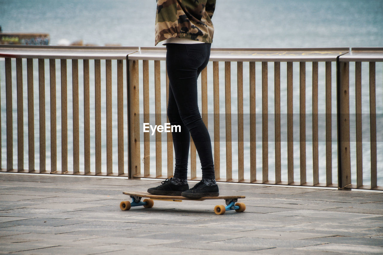 Low section of man standing on skateboard