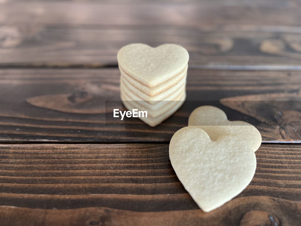 heart shape, love, positive emotion, emotion, heart, wood, valentine's day, romance, food and drink, cookie, food, sweet food, table, indoors, still life, freshness, close-up, baked, copy space, sweet, togetherness, shape, high angle view, simplicity, candy, celebration, selective focus