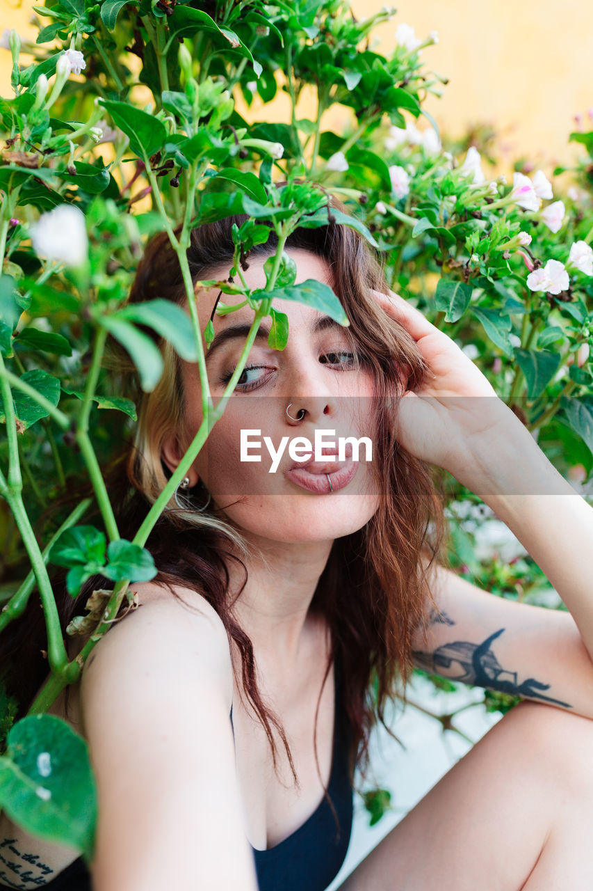 Photo of adorable young woman making selfie outdoors backyard