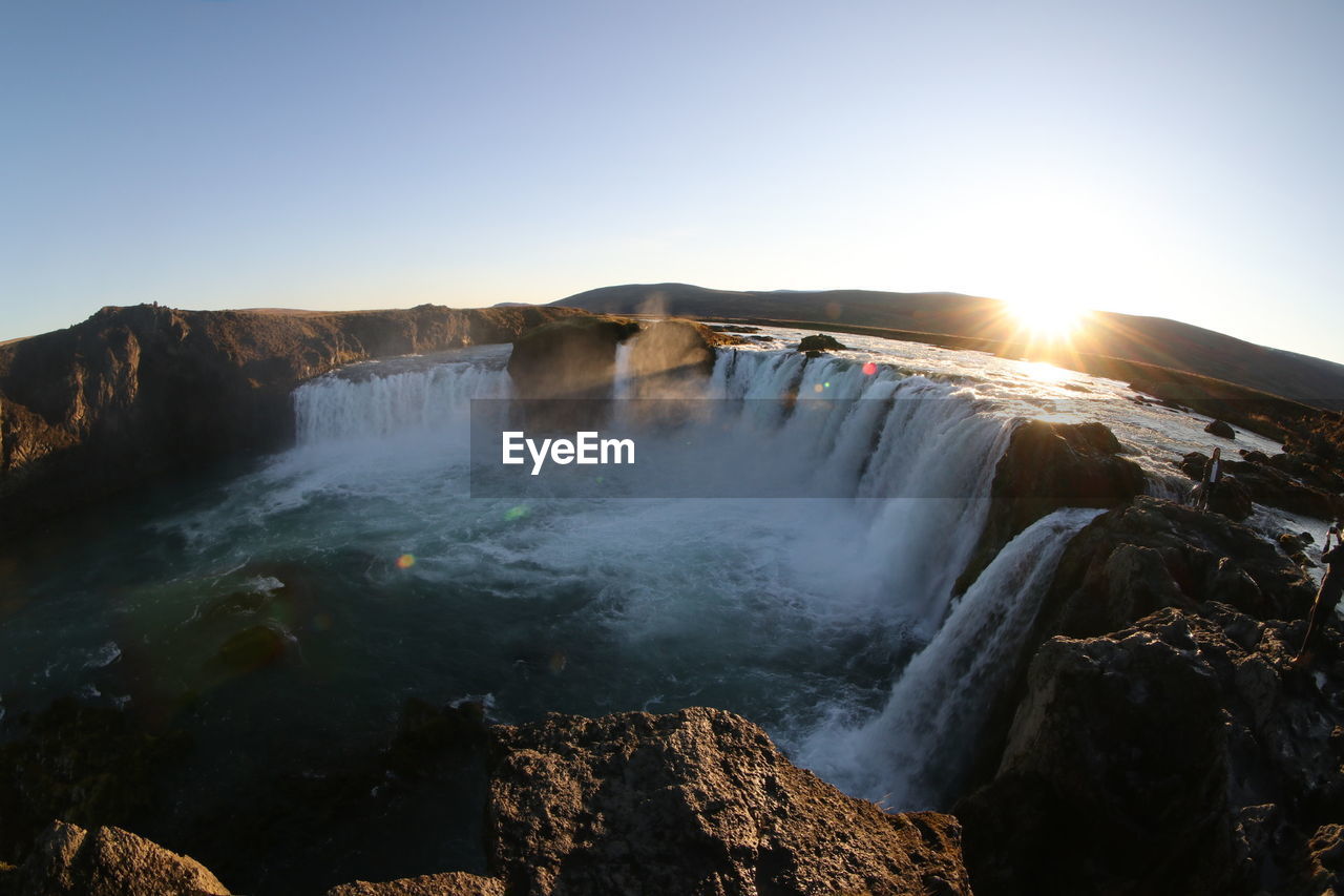 Scenic view of waterfall against clear sky