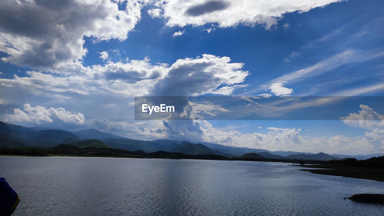 cloud, sky, mountain, water, scenics - nature, reflection, beauty in nature, environment, lake, landscape, mountain range, nature, tranquility, horizon, tranquil scene, travel, body of water, travel destinations, blue, dusk, land, no people, outdoors, day, holiday, non-urban scene, vacation, trip, tourism, idyllic, reservoir, sunlight
