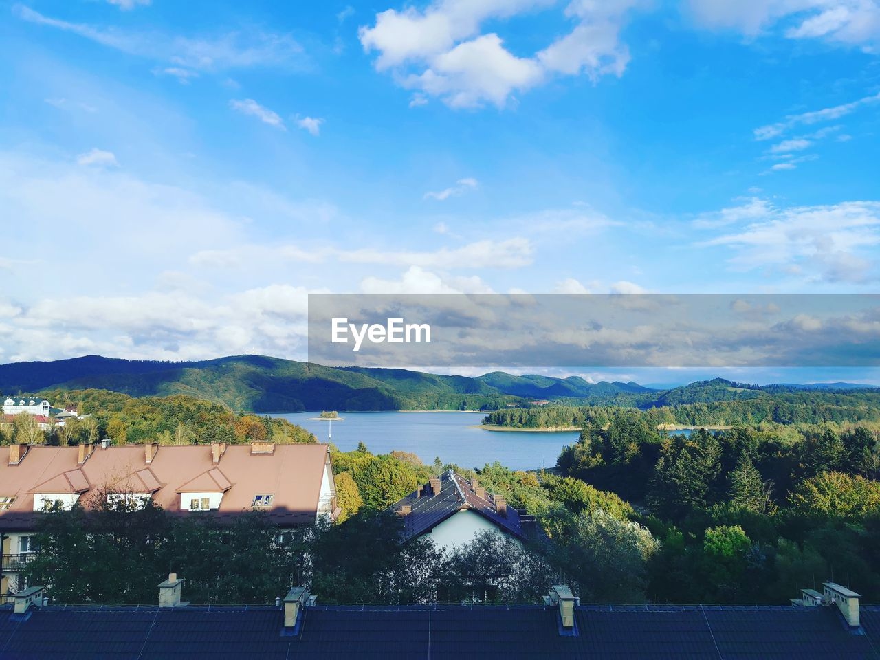 SCENIC VIEW OF BUILDINGS AND TREES AGAINST SKY