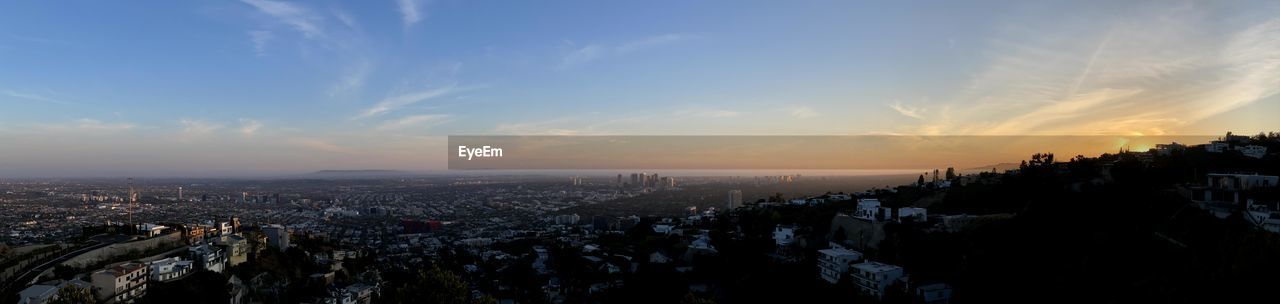 HIGH ANGLE VIEW OF CITY AGAINST CLOUDY SKY