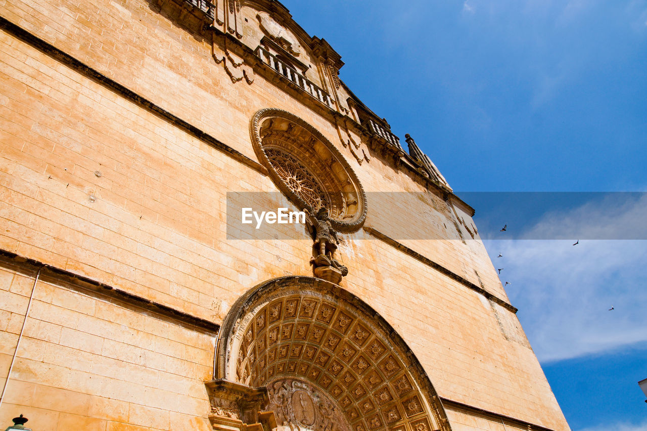 Low angle view of temple on building against sky