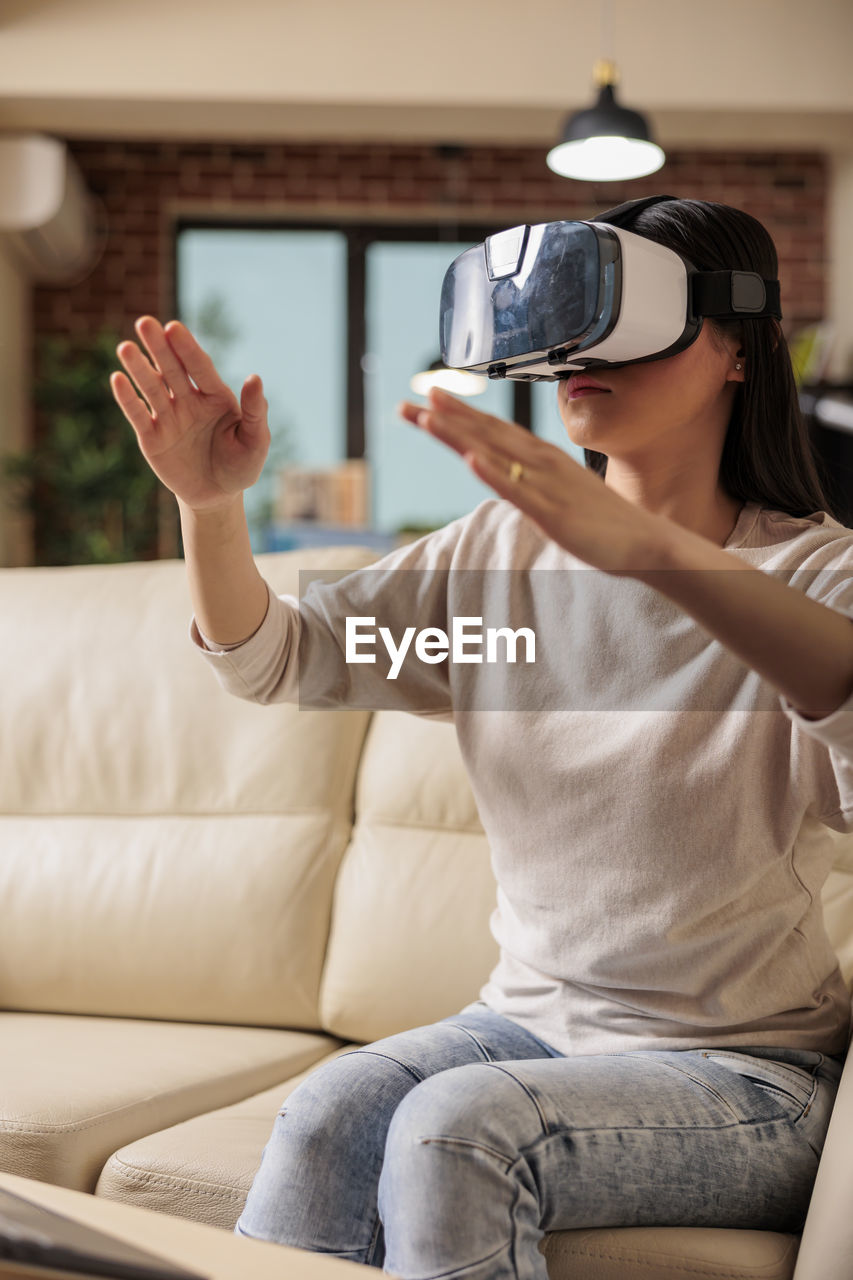 Woman wearing vr glasses at home