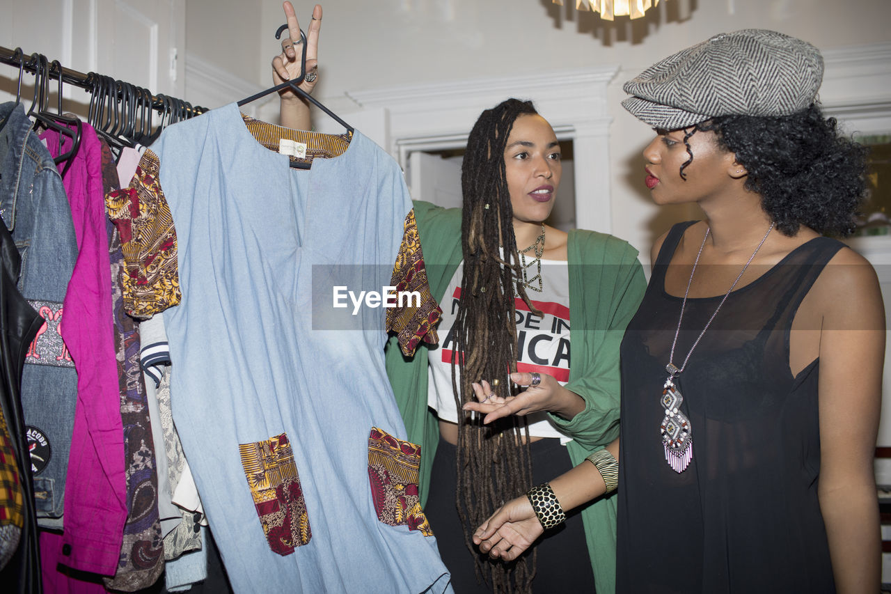 Two young women choosing an outfit