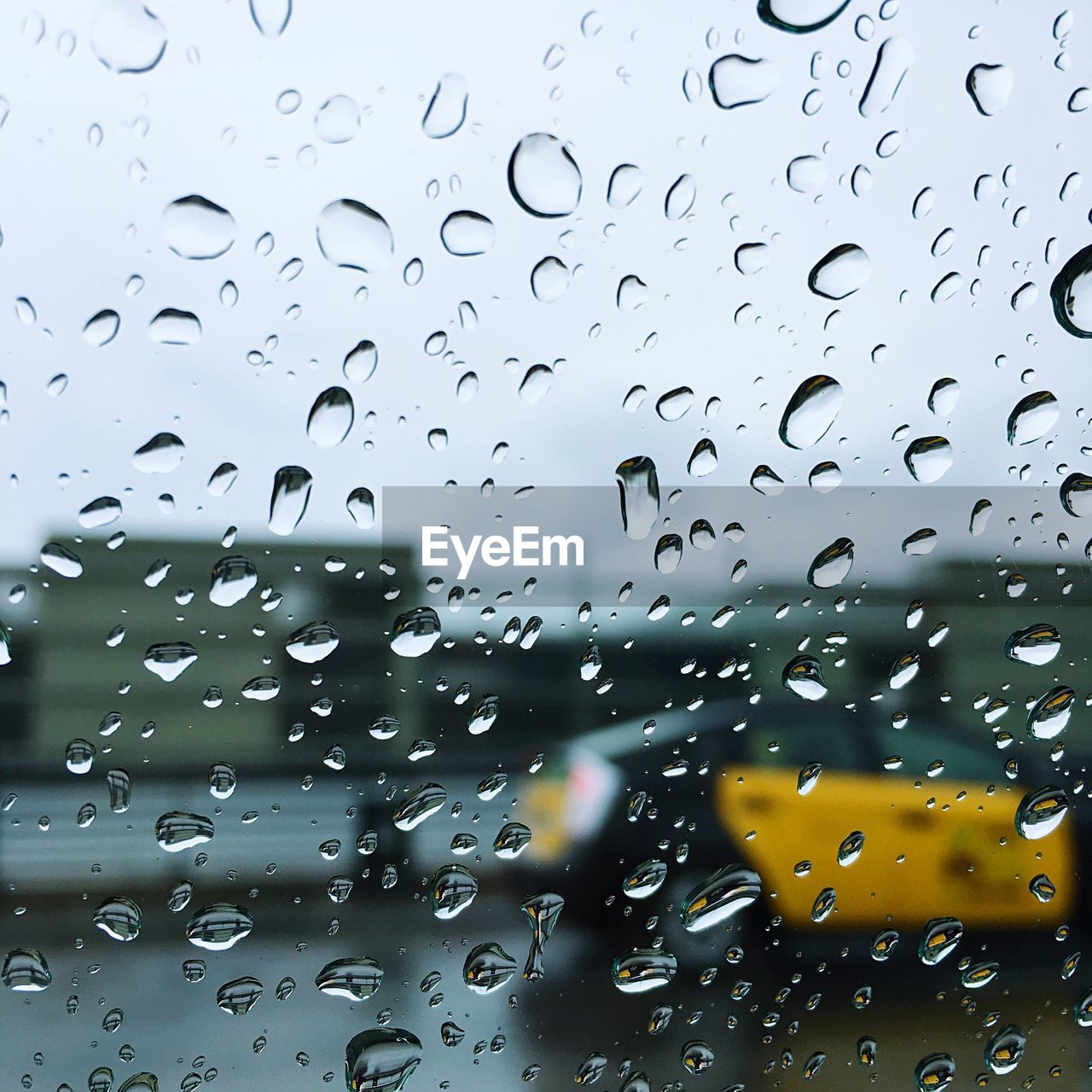 Close-up of wet car window during rainy season