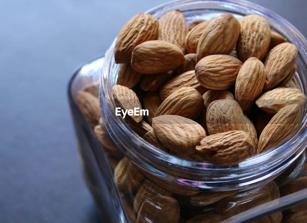 Close-up of almonds in jar on table