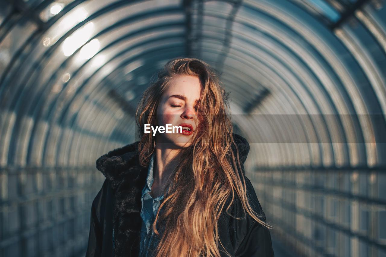 Portrait of a beautiful young woman standing outdoors