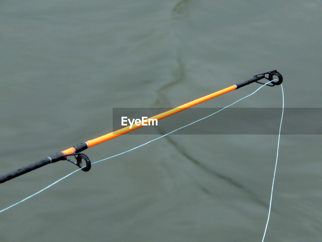 High angle view of fishing rod over lake