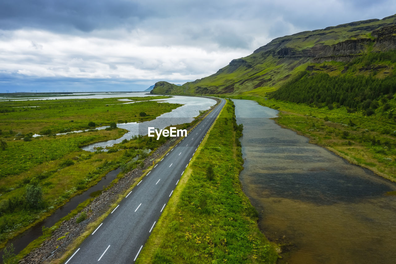 ROAD AMIDST LAND AGAINST SKY