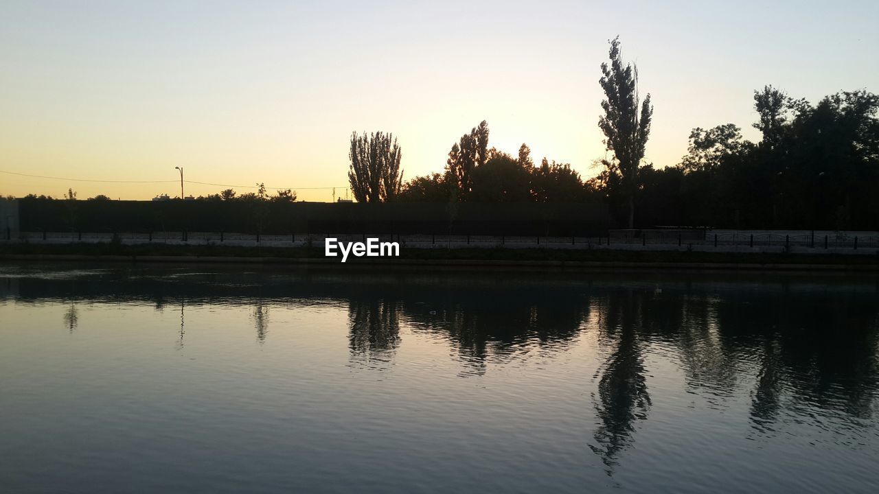 SCENIC VIEW OF LAKE AT SUNSET