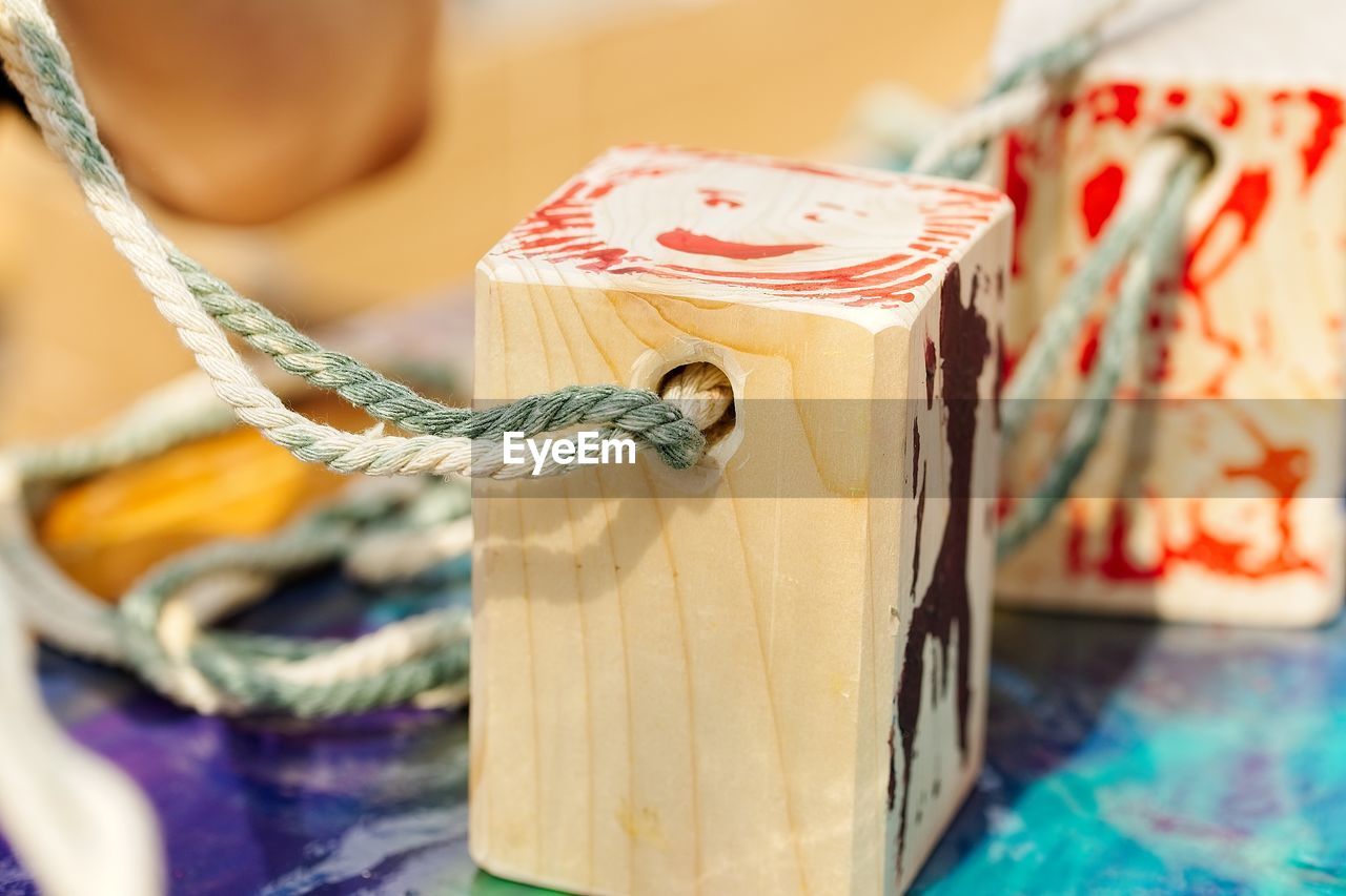 Close-up of rope tied up on wooden block