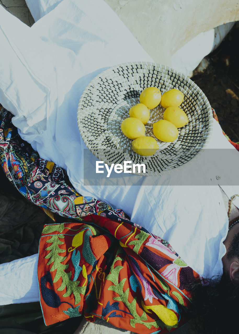 High angle view of man with lemon