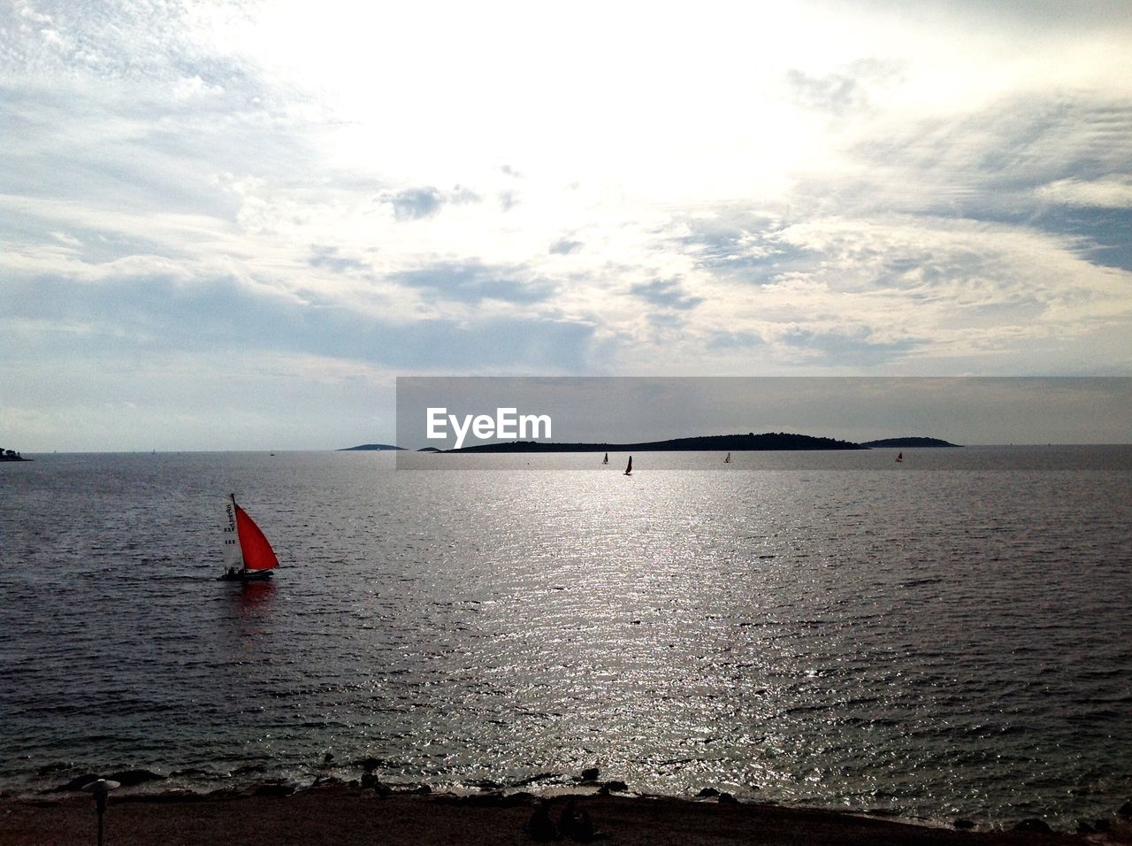 Sailboat sailing in sea against sky