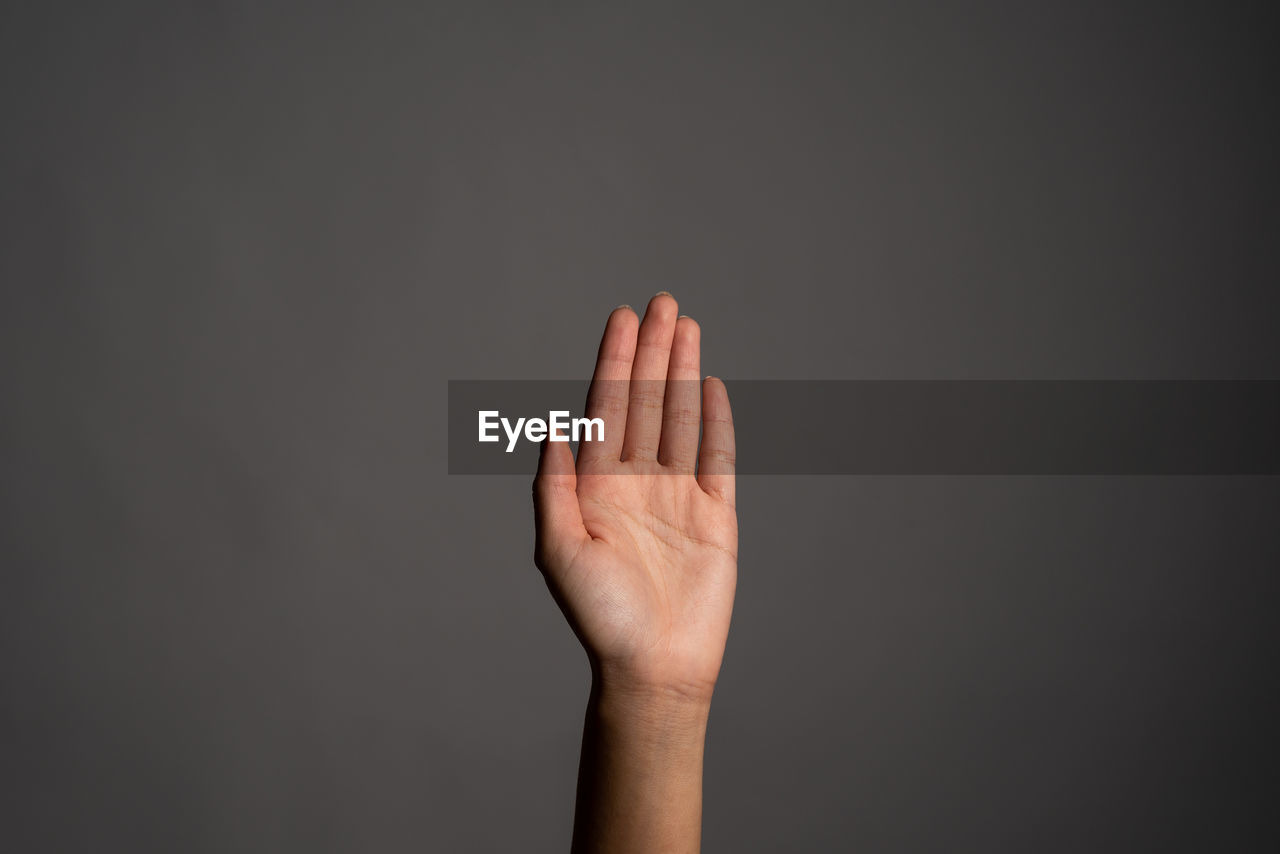 Close-up of human hand against black background