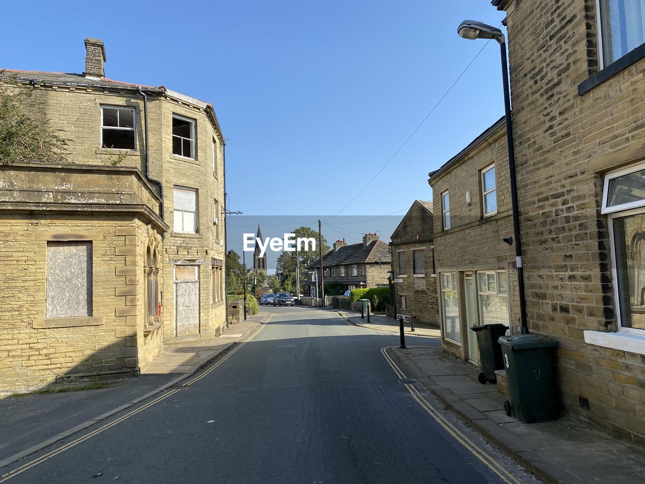 View along, market street, with victorian buildings, and a blue sky in, thornton, bradford, uk