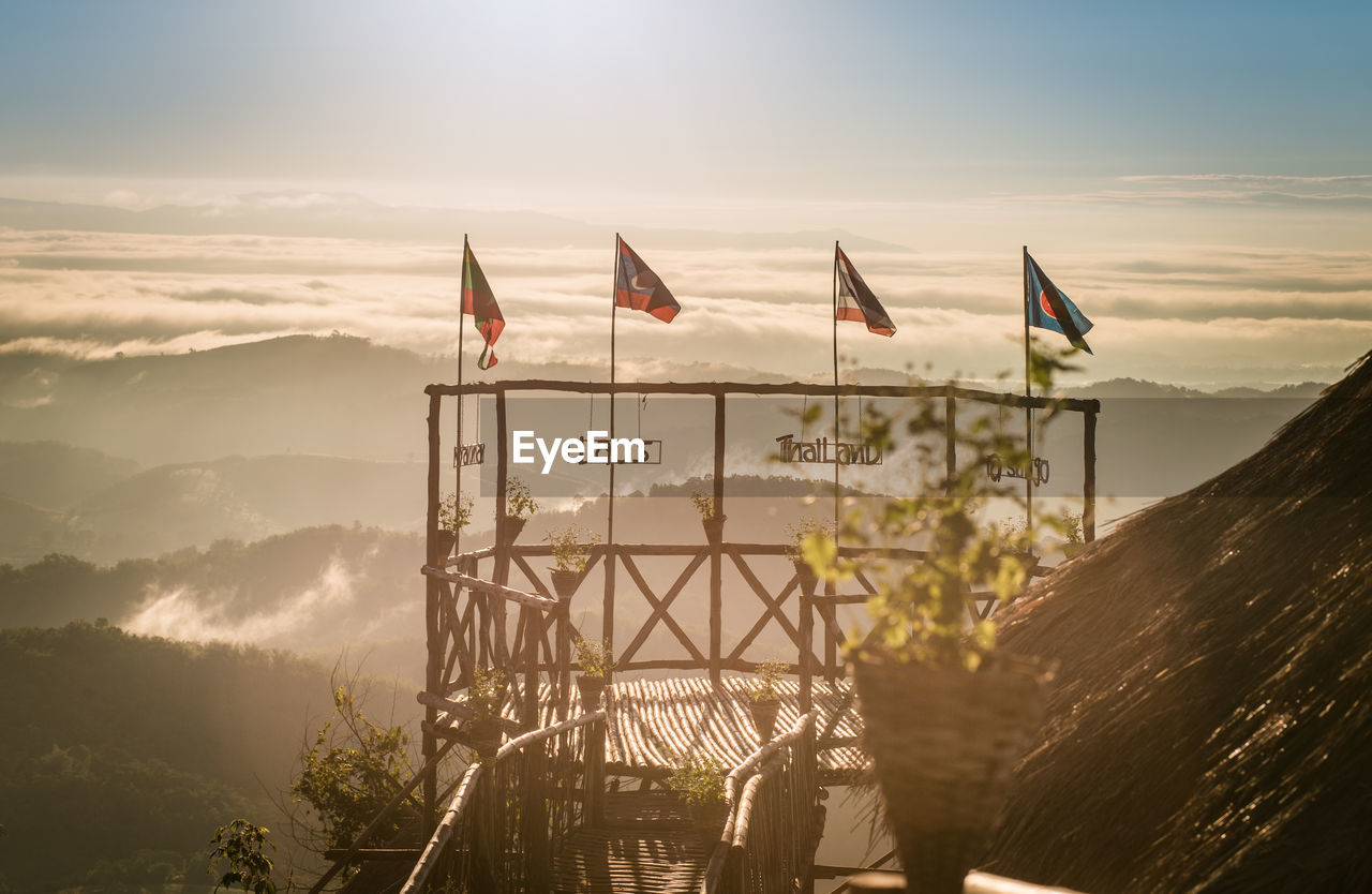 FLAGS ON MOUNTAIN AGAINST SKY