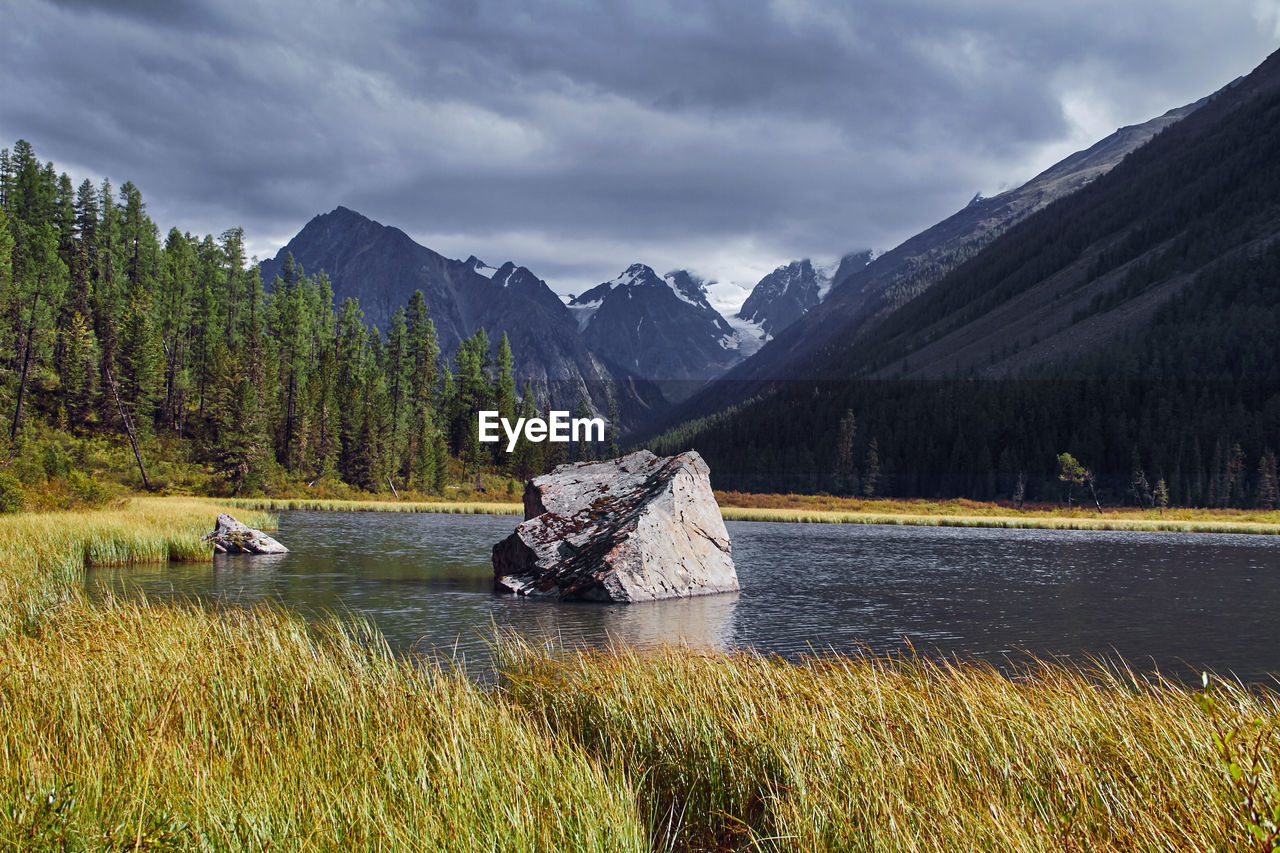 Scenic view of lake and mountains against sky