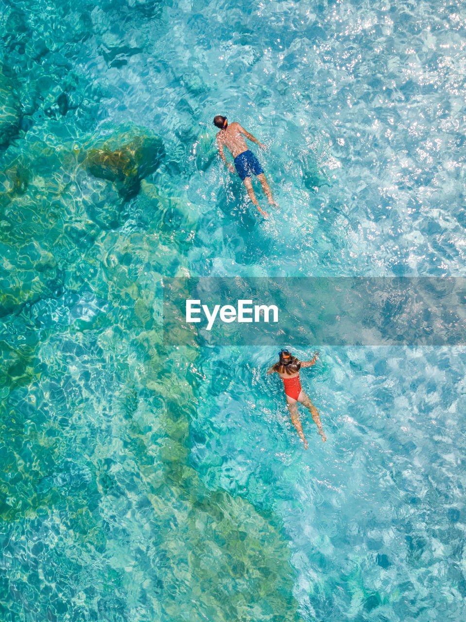 high angle view of woman swimming in sea