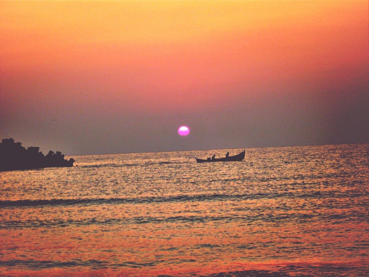 SILHOUETTE OF BOAT IN SEA AT SUNSET