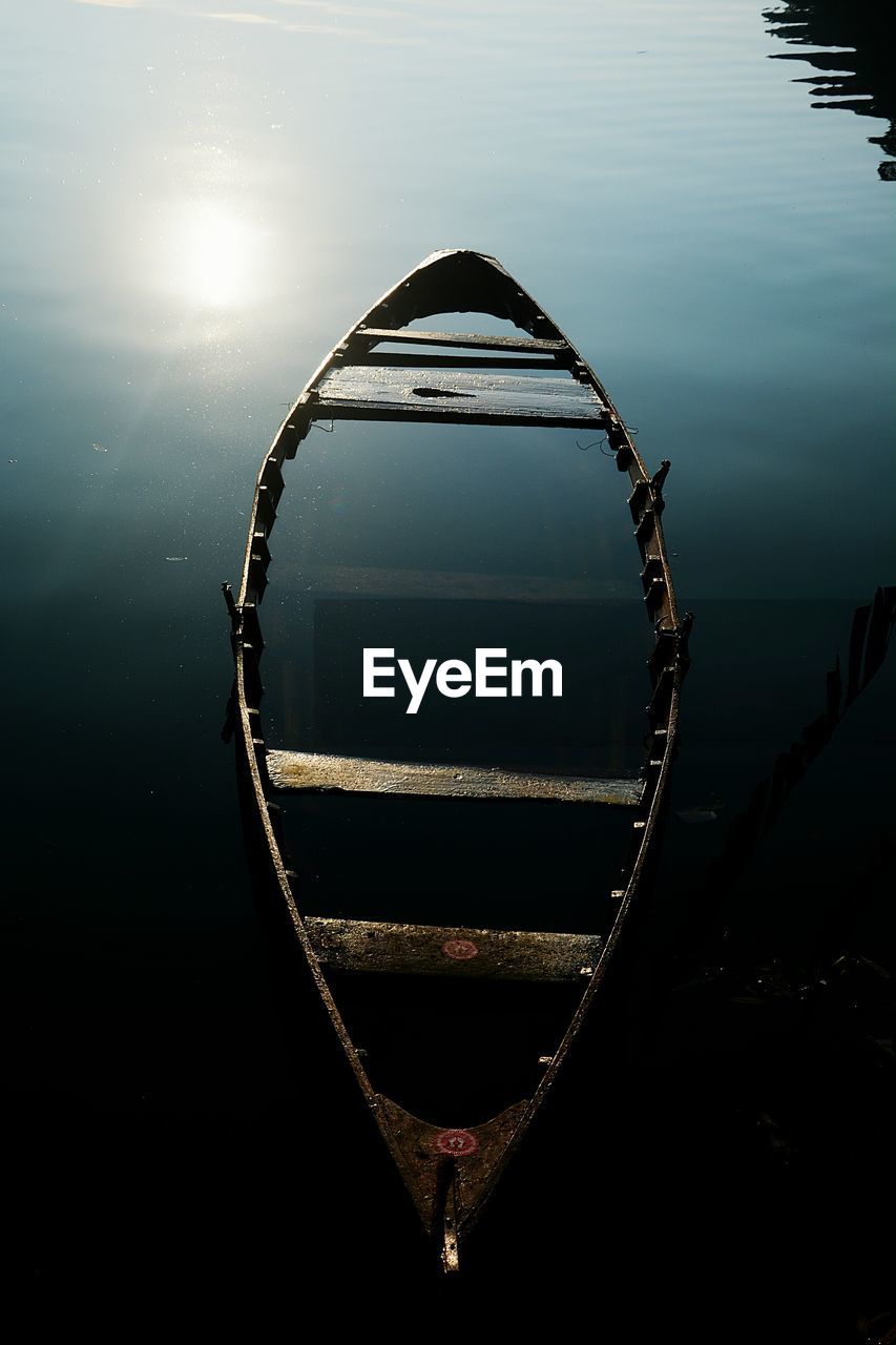 High angle view of damaged boat sinking in lake