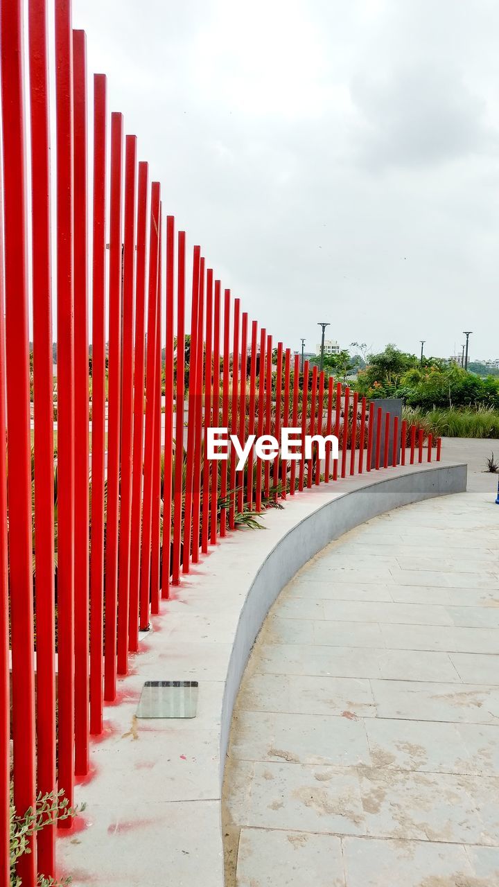 Red poles against sky