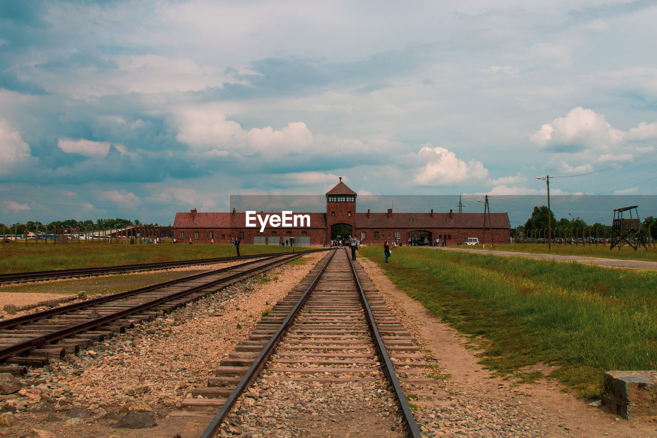 VIEW OF RAILROAD TRACKS ALONG PLANTS AND BUILDINGS